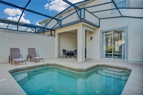 a swimming pool with outdoor seating