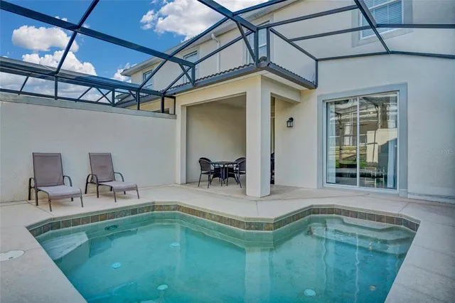 a swimming pool with outdoor seating