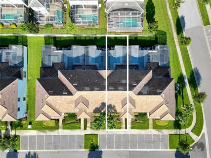 an aerial view of multi story residential apartment building with swimming pool