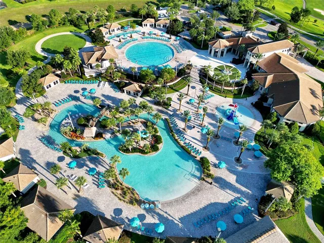 an aerial view of residential houses with outdoor space and street view