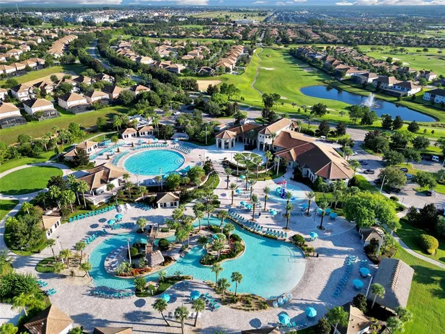 an aerial view of residential houses with outdoor space and river view
