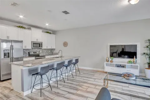 a kitchen with stainless steel appliances kitchen island granite countertop a stove and a sink