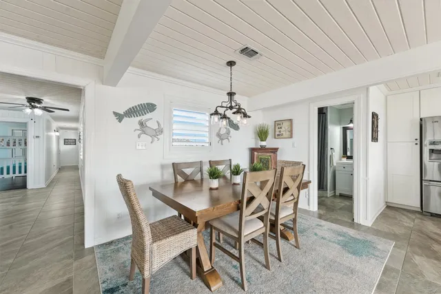 a view of a dining room with furniture and chandelier
