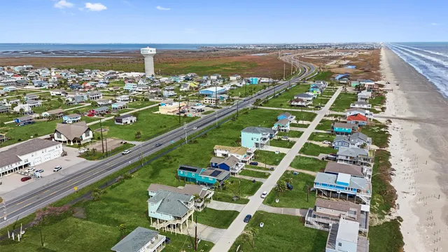 a view of a house with a yard deck and a patio