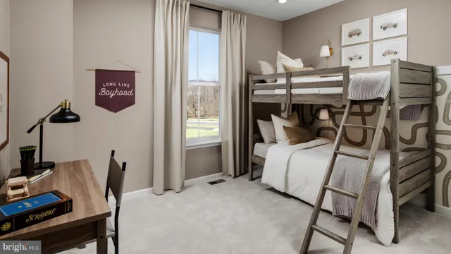 a bedroom with a bed and a desk