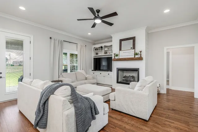 a living room with furniture fireplace and a flat screen tv