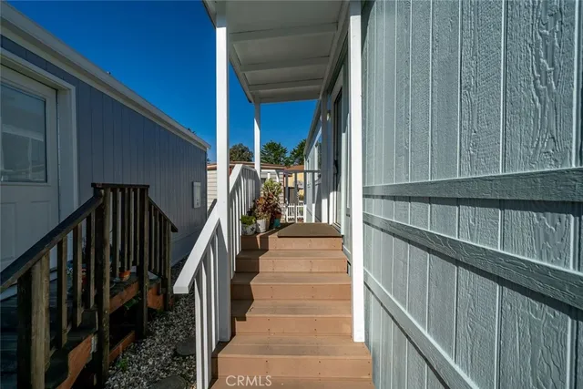 a view of staircase with railing and white walls