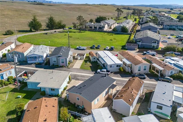 an aerial view of a house with a garden and lake view