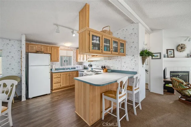 a kitchen with kitchen island a stove a table and chairs