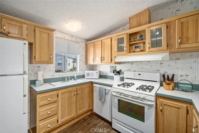 a kitchen with a sink stove and refrigerator