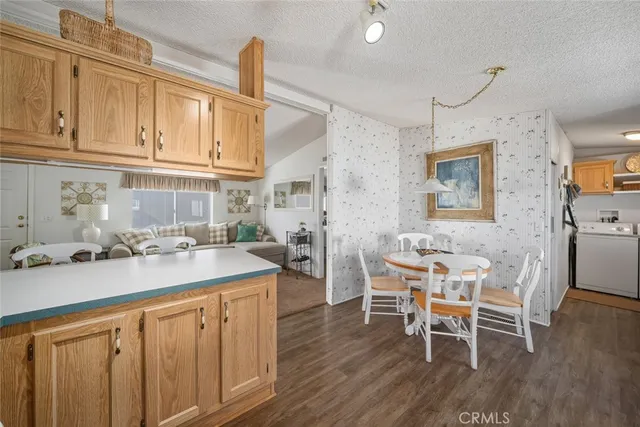 a kitchen with a sink cabinets and wooden floor