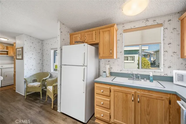 a kitchen with a refrigerator a sink and a stove top oven