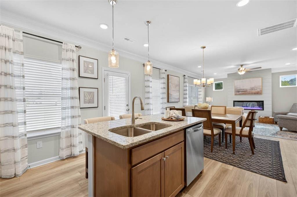 498 Guy Williams Road Rock Spring, GA 30739 - Photo 11 of 42 a kitchen that has a sink a table and chairs in it