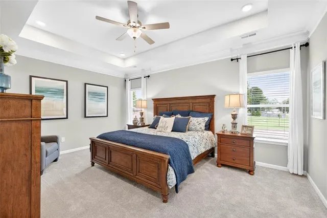 a bedroom with a bed dresser and a window