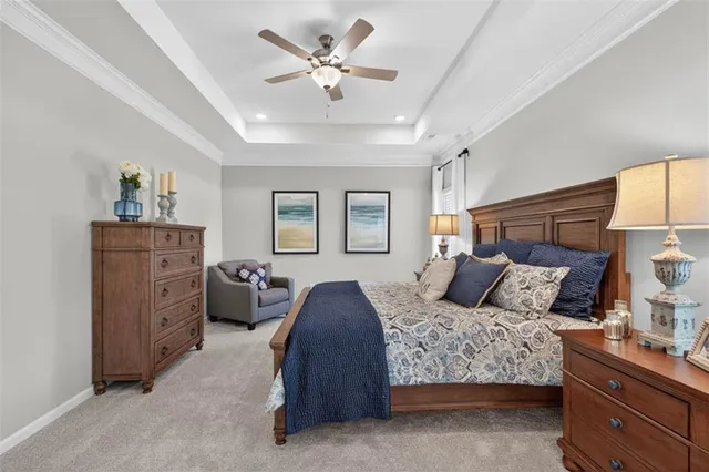 a bedroom with a large bed and a chandelier