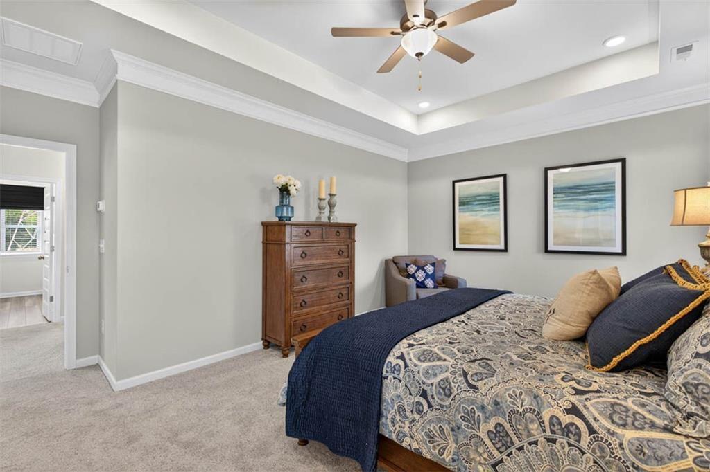 498 Guy Williams Road Rock Spring, GA 30739 - Photo 30 of 42 a bedroom with a bed and a chandelier