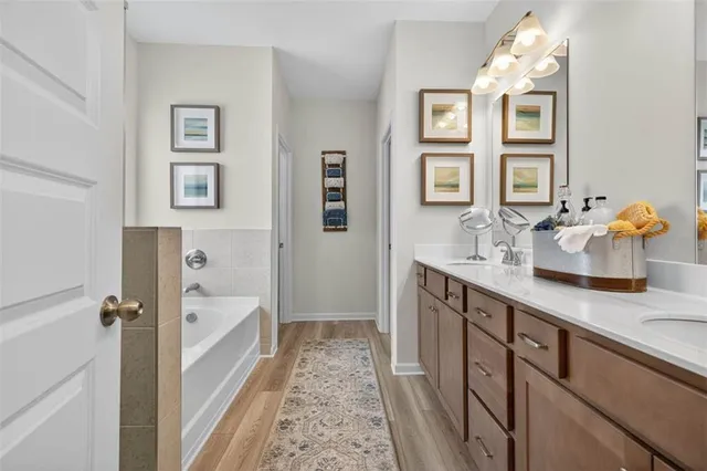 a bathroom with a sink double vanity granite tub and shower