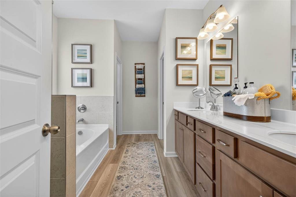 498 Guy Williams Road Rock Spring, GA 30739 - Photo 31 of 42 a bathroom with a sink double vanity granite tub and shower