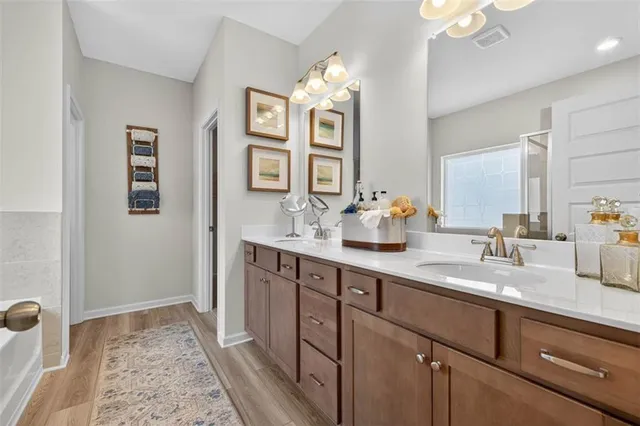 a spacious bathroom with a double vanity sink and a mirror