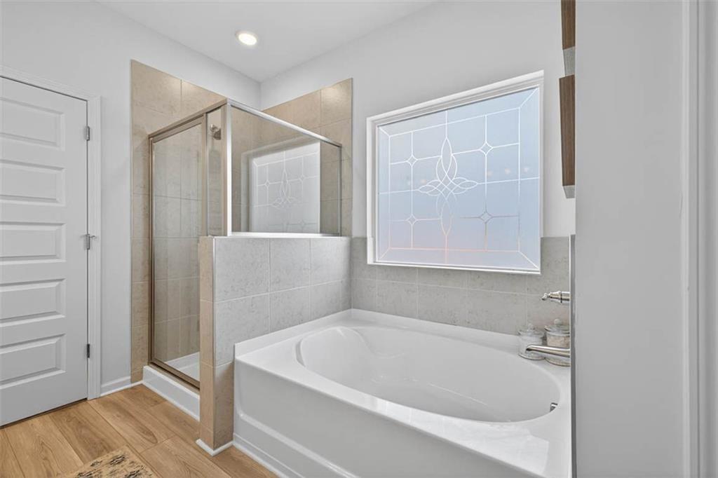 498 Guy Williams Road Rock Spring, GA 30739 - Photo 33 of 42 a bathroom with a bathtub and a shower