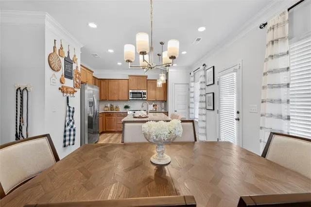 a living room with kitchen island furniture and a chandelier