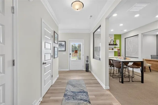 a view of a hallway with furniture and front door