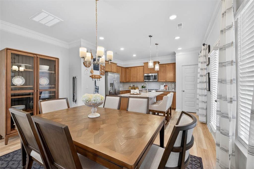498 Guy Williams Road Rock Spring, GA 30739 - Photo 5 of 42 a kitchen with stainless steel appliances kitchen island granite countertop a dining table chairs and granite counter tops