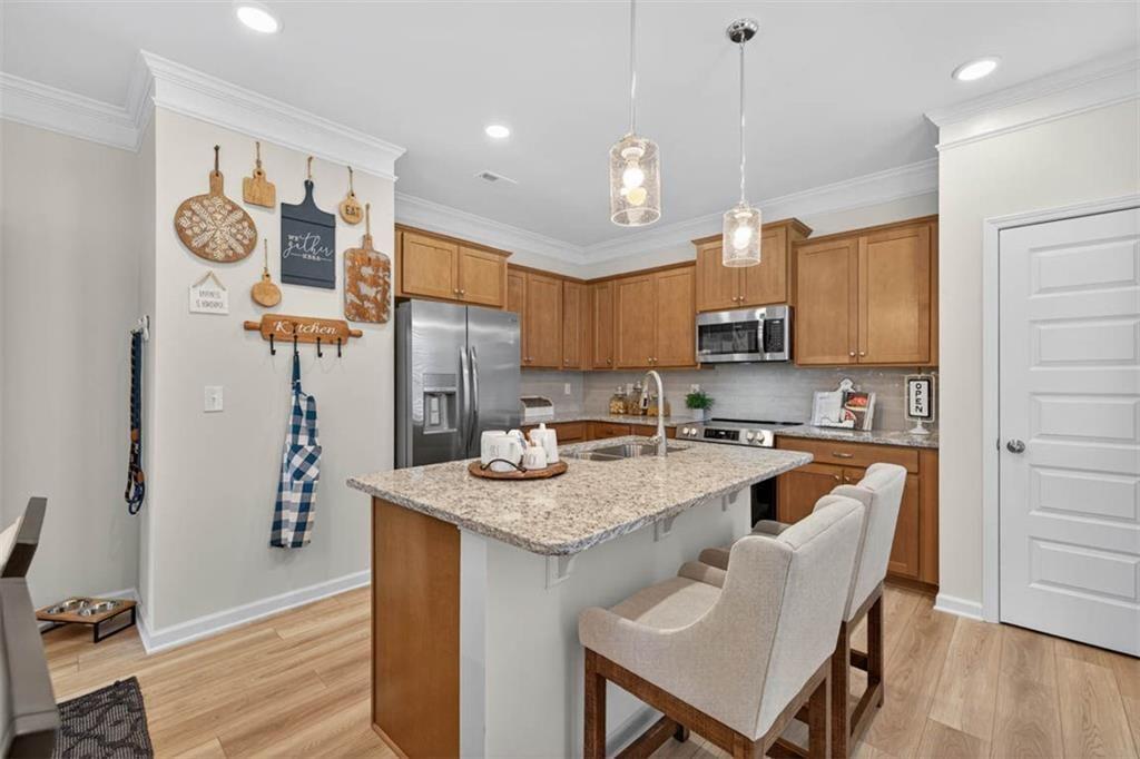 498 Guy Williams Road Rock Spring, GA 30739 - Photo 8 of 42 a kitchen with stainless steel appliances granite countertop a sink refrigerator and cabinets