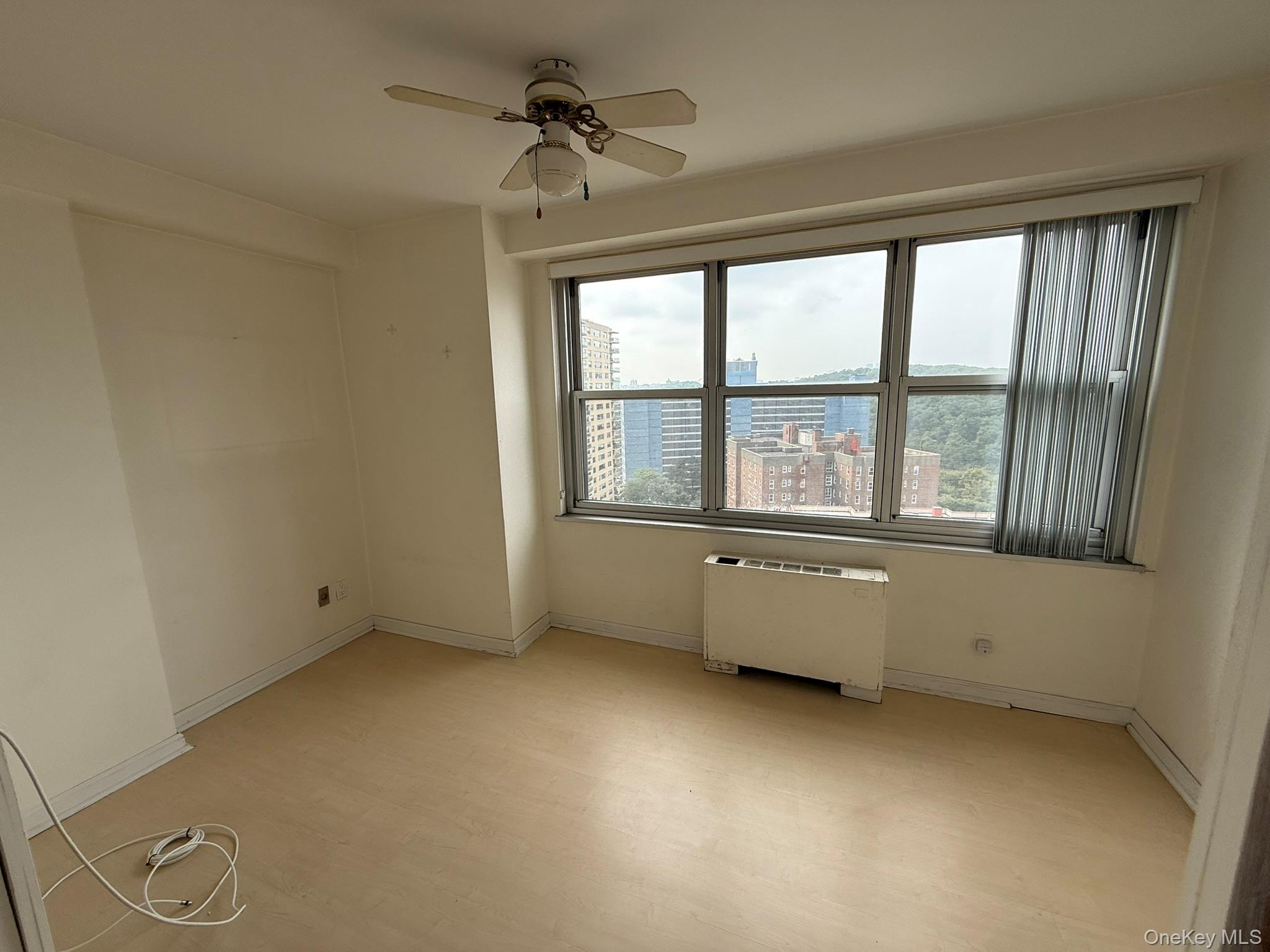 555 Kappock Street, Unit 11P Bronx, NY 10463 - Photo 11 of 15 a view of an empty room with a window