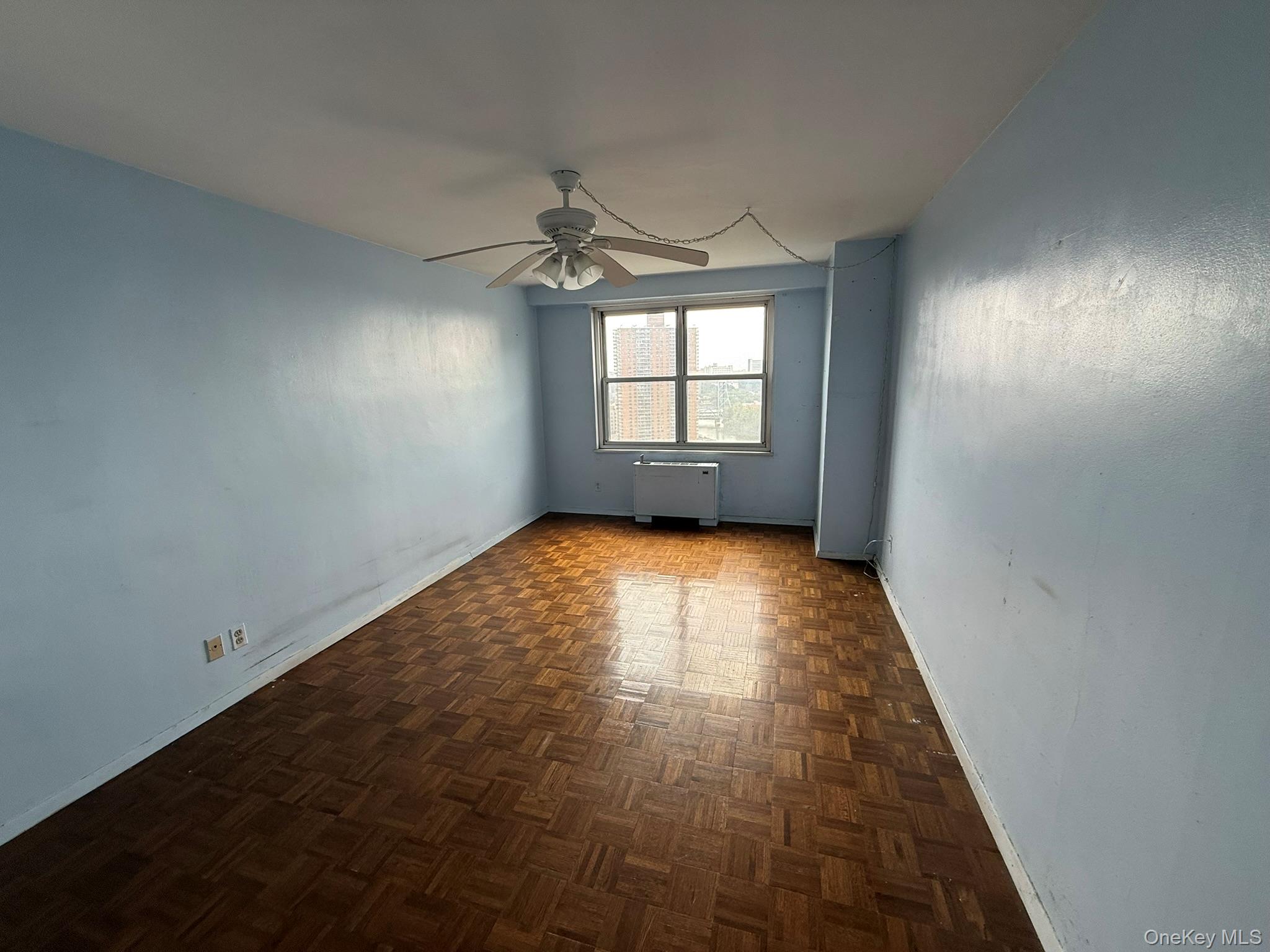555 Kappock Street, Unit 11P Bronx, NY 10463 - Photo 10 of 15 wooden floor in an empty room with a window