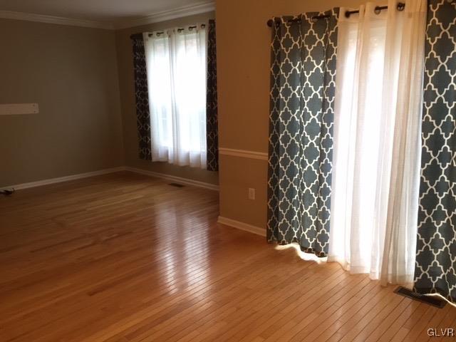 4224 Creek Road Allentown, PA 18104 - Photo 4 of 19 a view of an empty room with wooden floor and a window