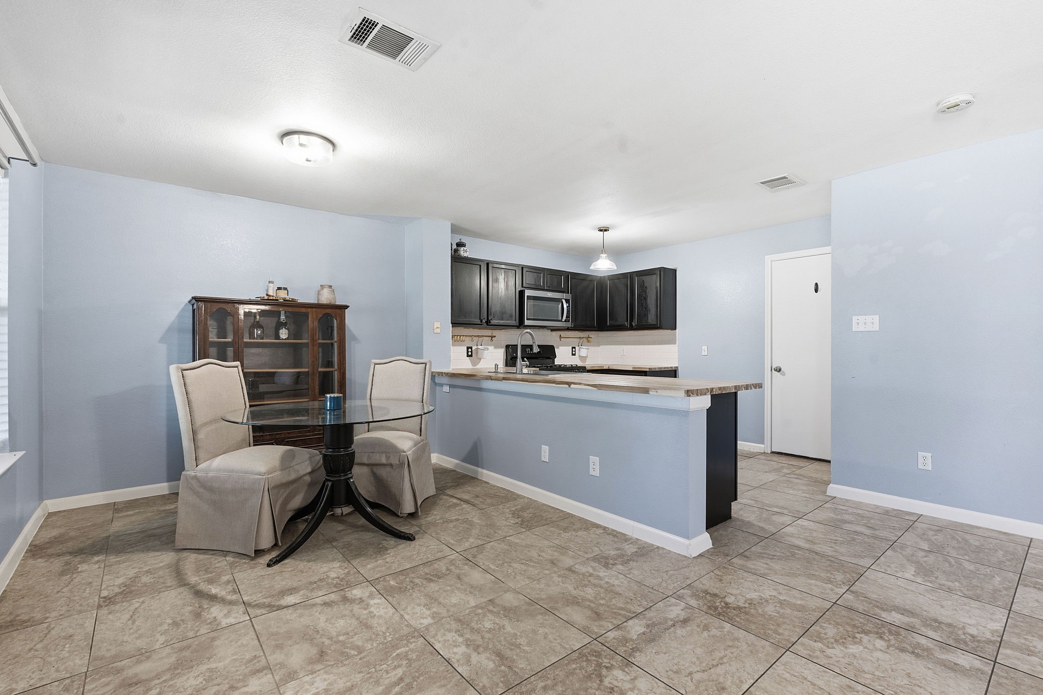 229 Black Forest Road Buda, TX 78610 - Photo 11 of 32 a kitchen with a cabinets and a refrigerator