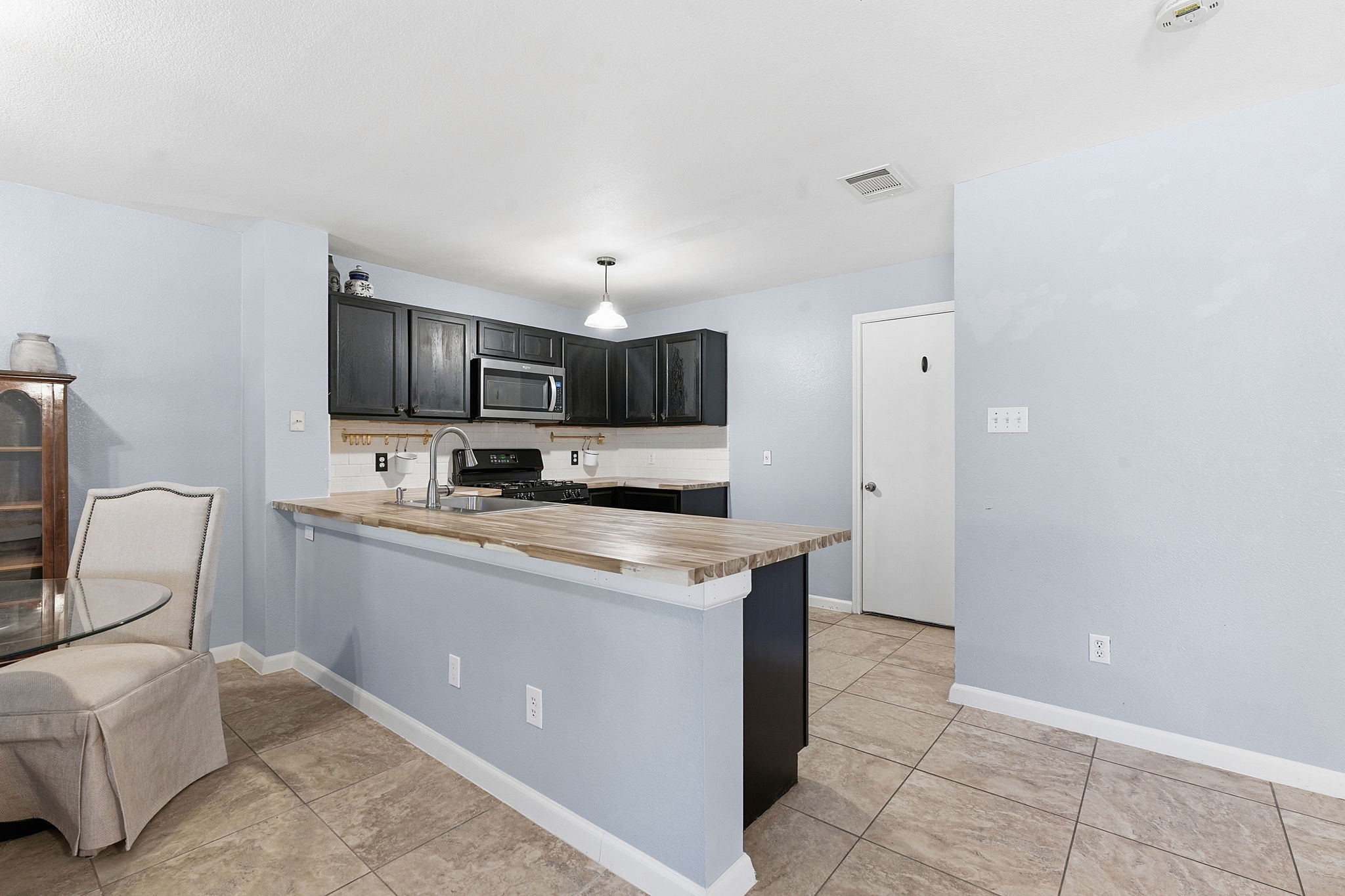 229 Black Forest Road Buda, TX 78610 - Photo 12 of 32 a kitchen with a sink cabinets and appliances