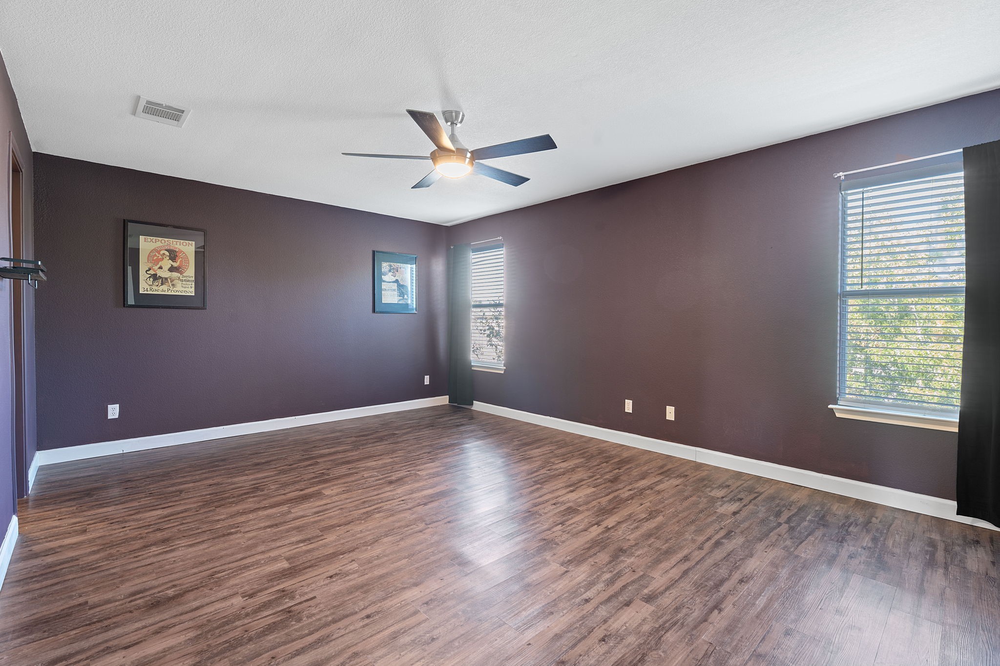 229 Black Forest Road Buda, TX 78610 - Photo 17 of 32 a view of an empty room with window and wooden floor