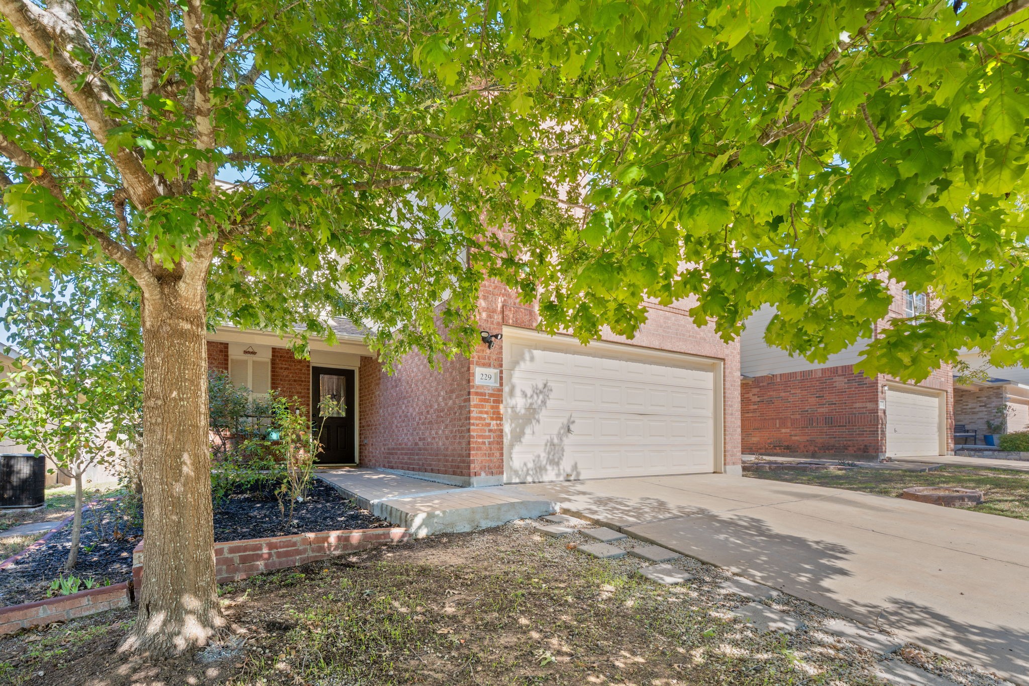 229 Black Forest Road Buda, TX 78610 - Photo 3 of 32 a front view of a house with a yard and garage