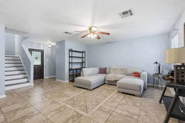 a bedroom with furniture and a chandelier fan