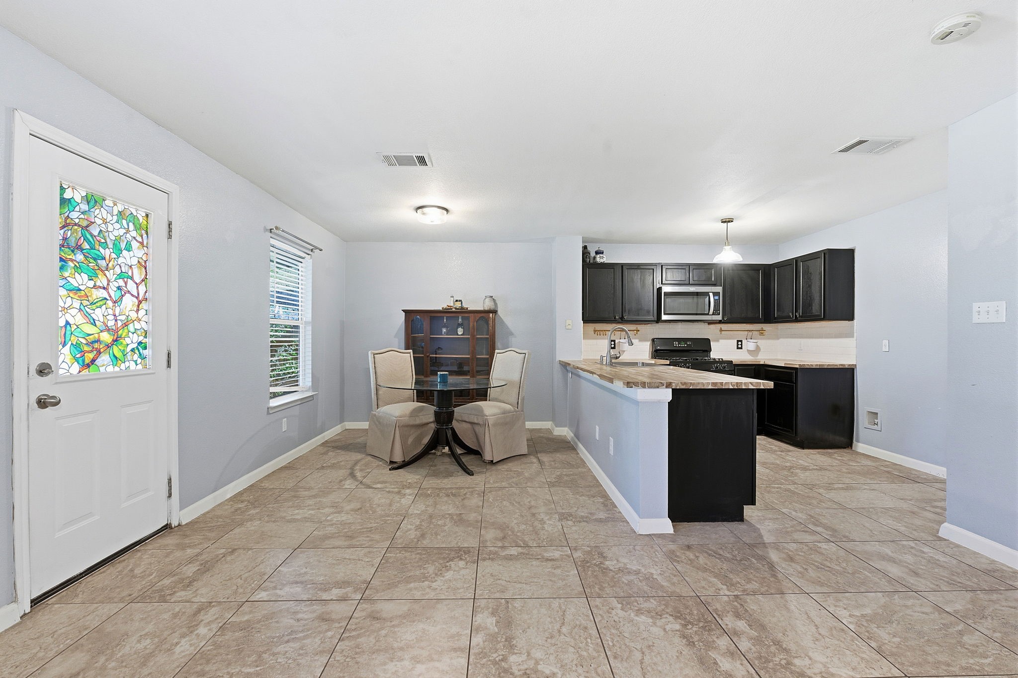 229 Black Forest Road Buda, TX 78610 - Photo 9 of 32 a kitchen with a sink a counter top space and appliances