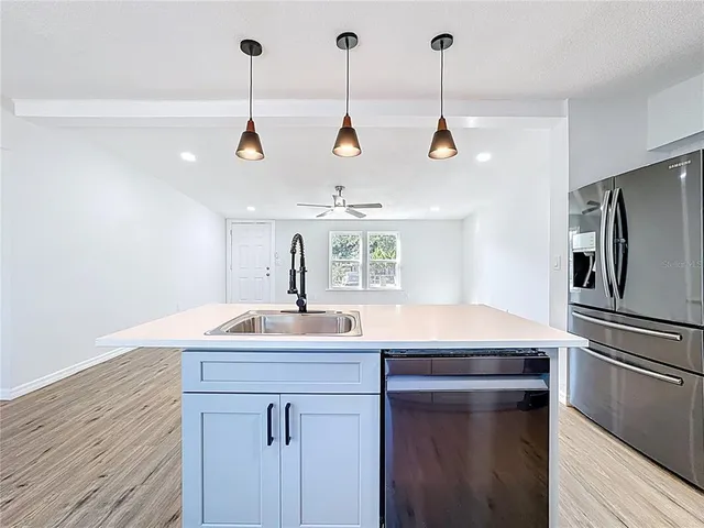a kitchen with a sink and refrigerator