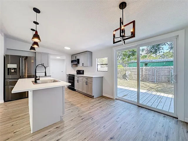 a view of kitchen with sink and wooden floor