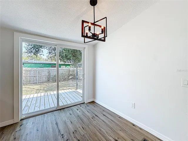 a view of a room with wooden floor and window