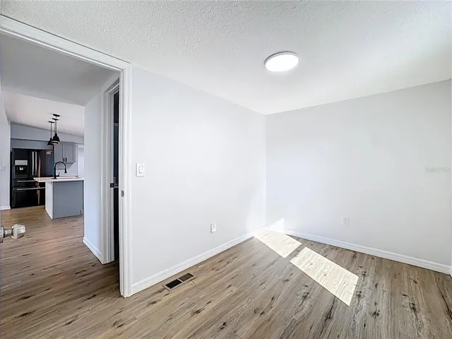 a view of a kitchen with wooden floor and a kitchen