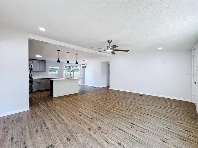 a view of a kitchen with a sink and microwave