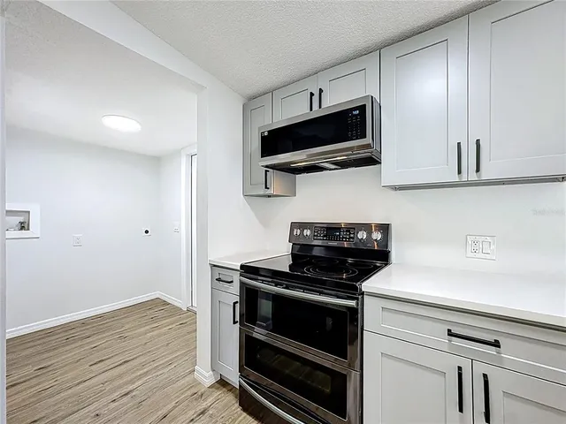 a kitchen with a microwave and cabinets