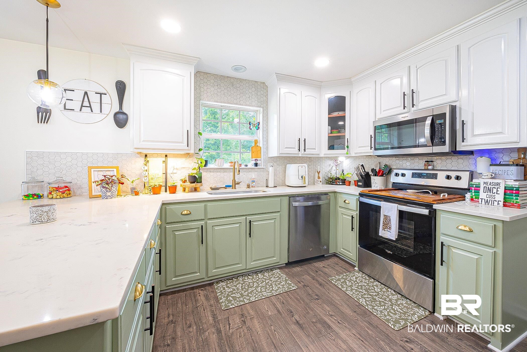 5304 Lansdowne Drive Mobile, AL 36693 - Photo 7 of 28 Kitchen featuring appliances with stainless steel finishes, gold fixtures, quartz countertops, and marble honeycomb backsplash.