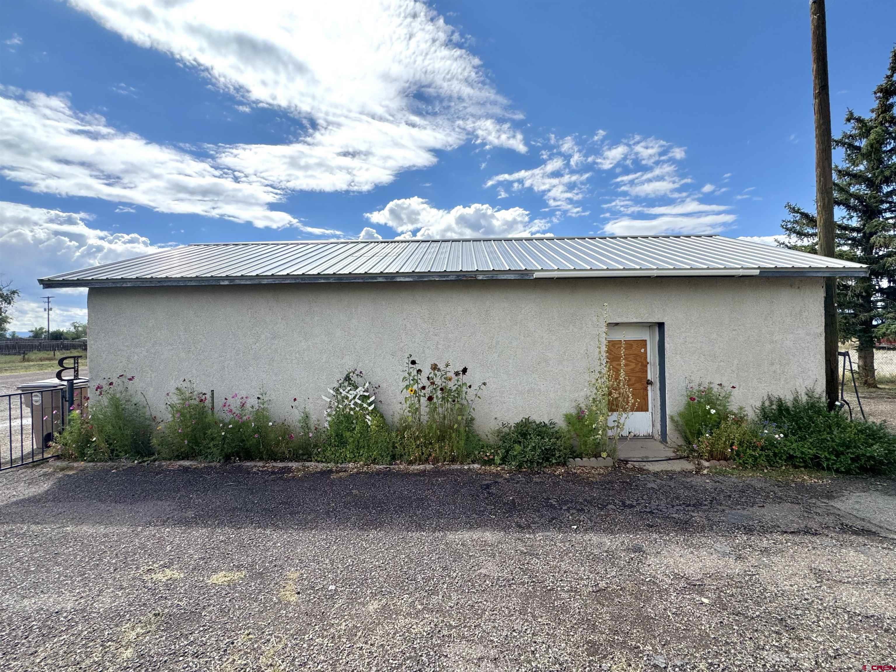 113 Conejos Street Romeo, CO 81148 - Photo 11 of 36 a view of a house with a plants