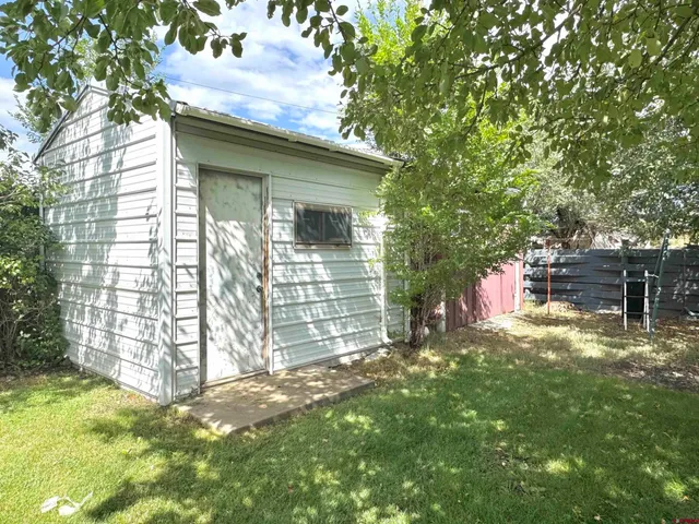 a backyard of a house with table and chairs