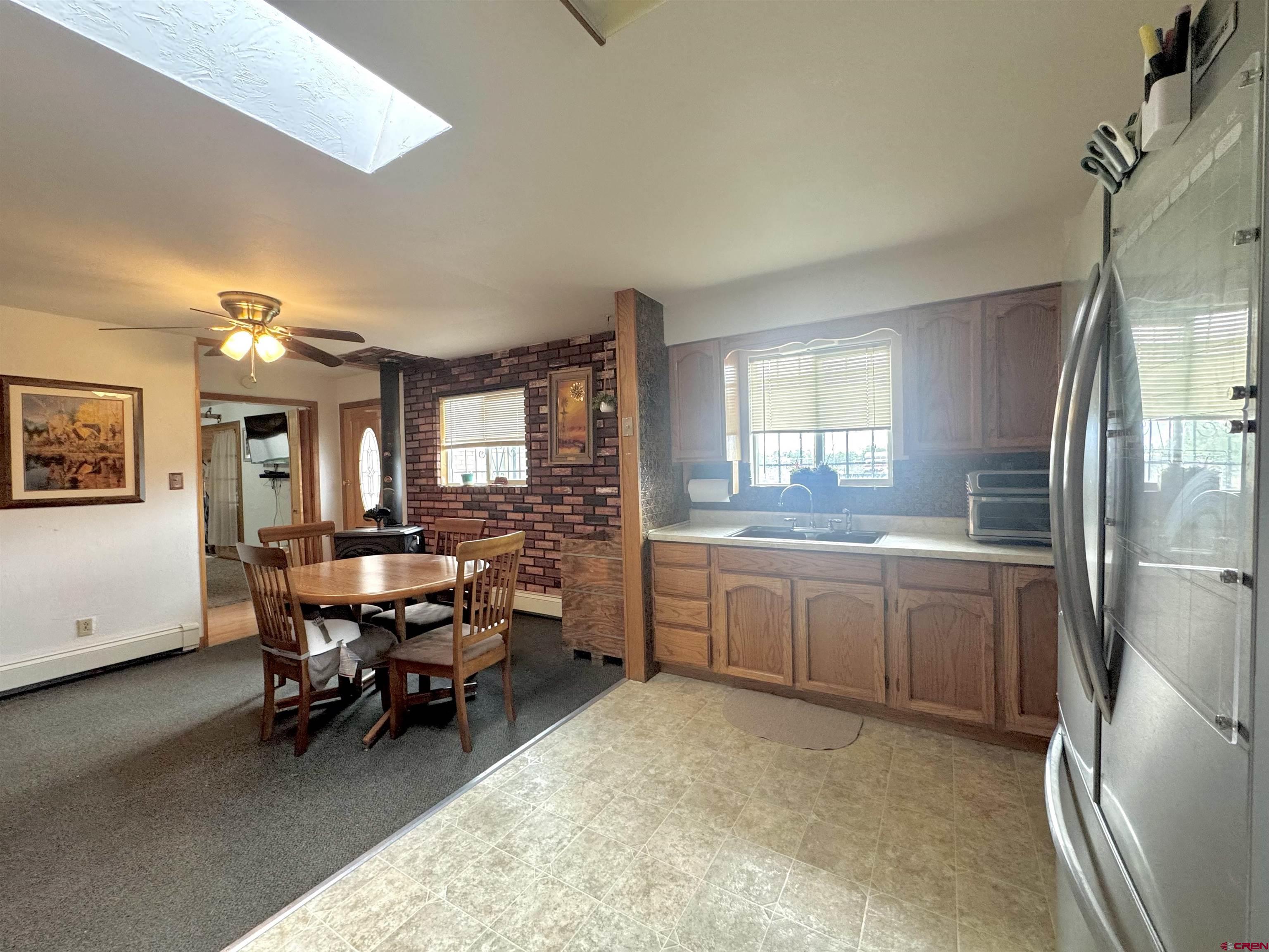 113 Conejos Street Romeo, CO 81148 - Photo 15 of 36 a kitchen with sink and refrigerator