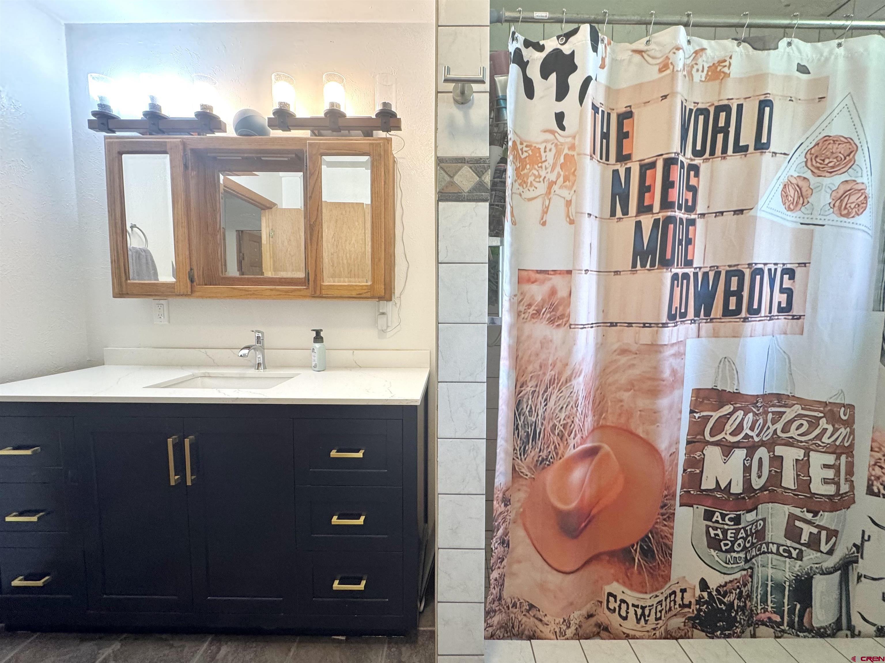 113 Conejos Street Romeo, CO 81148 - Photo 22 of 36 a bathroom with a sink and a mirror