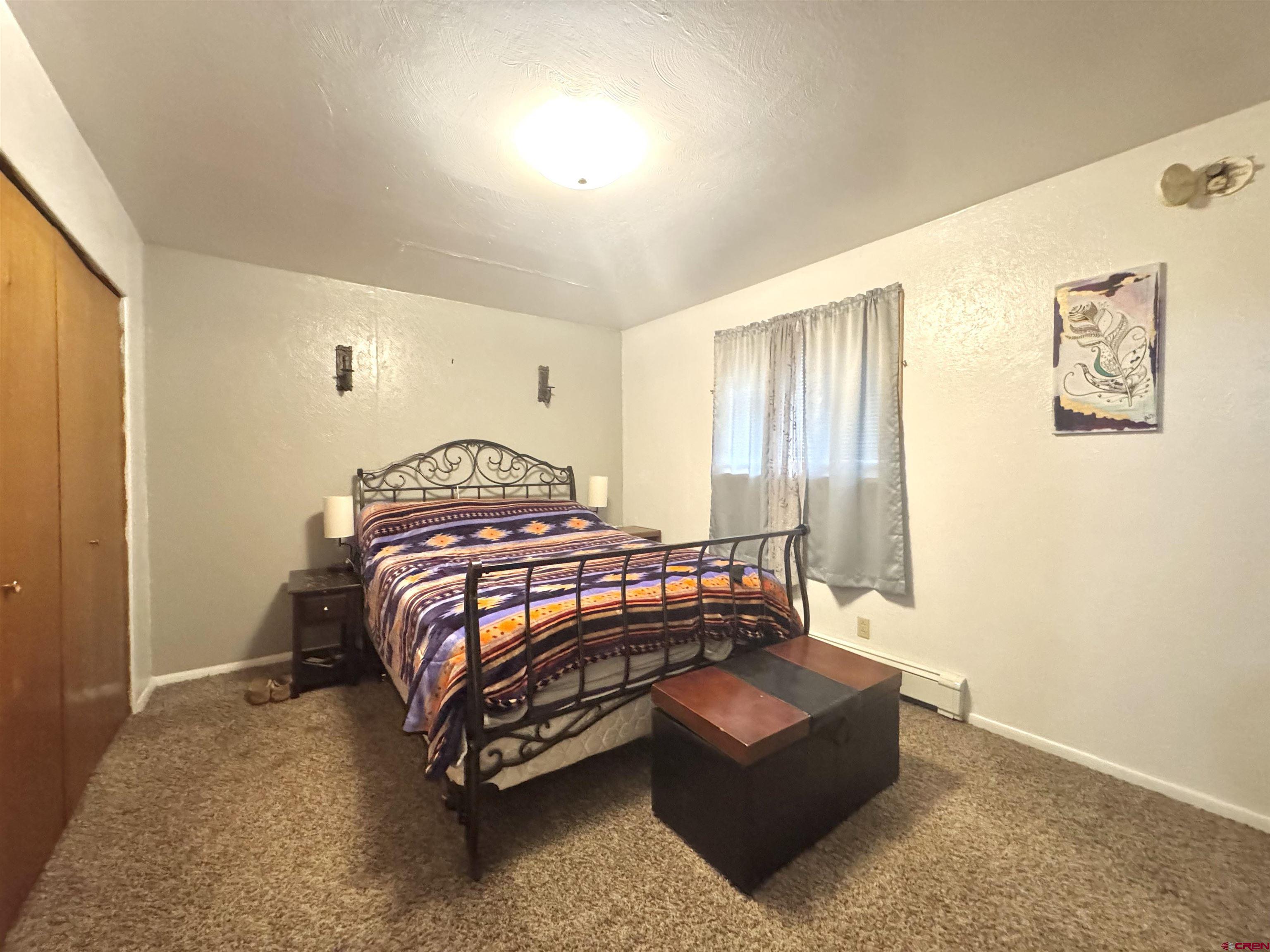 113 Conejos Street Romeo, CO 81148 - Photo 25 of 36 a bedroom with a bed and window