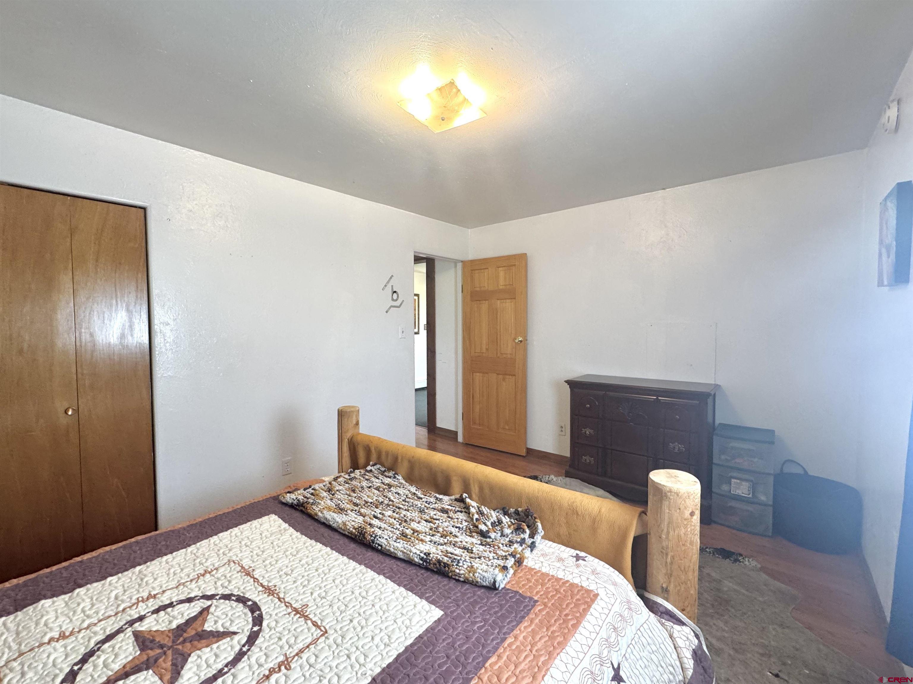 113 Conejos Street Romeo, CO 81148 - Photo 27 of 36 a bedroom with a bed and a window